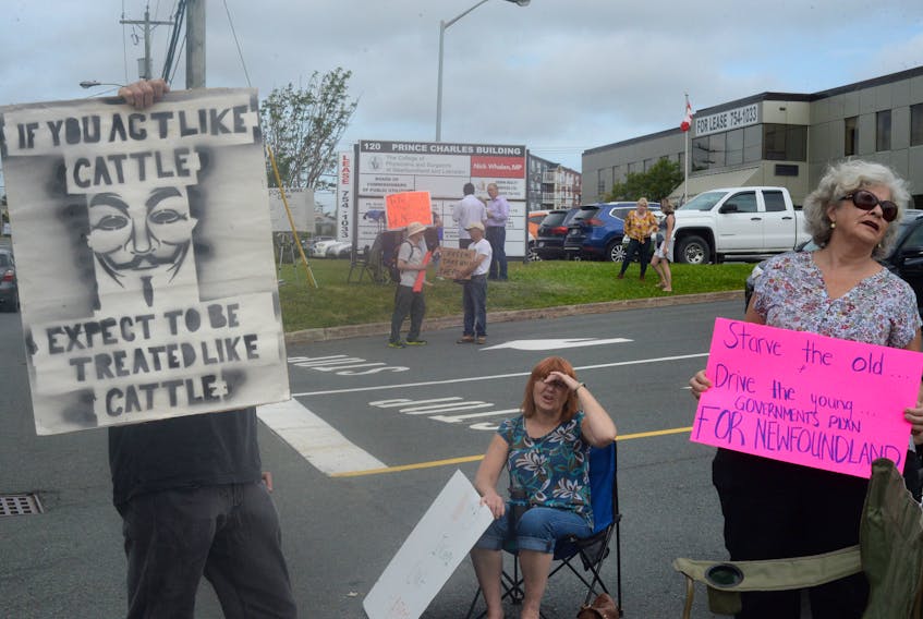 Protesters outside the Public Utilities Board building on Torbay Road in St. John’s Thursday. — Joe Gibbons/The Telegram