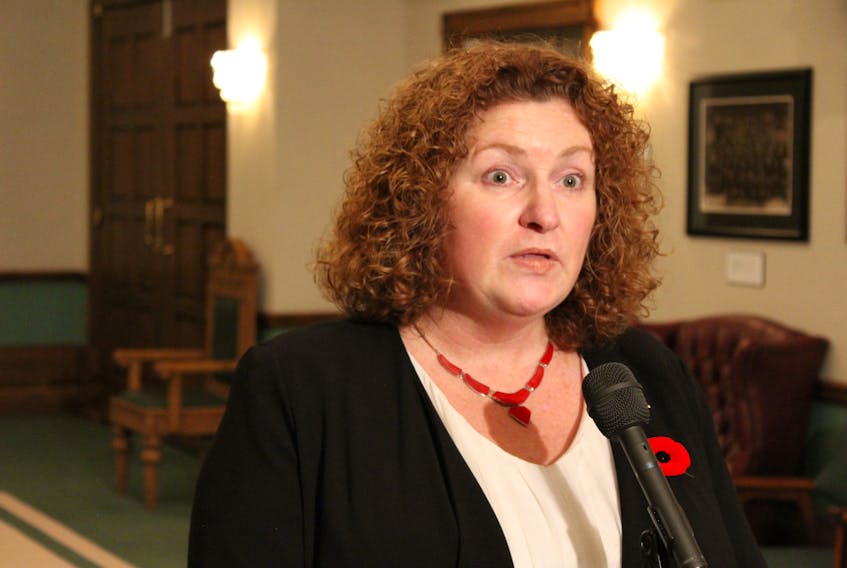 Service NL Minister Sherry Gambin-Walsh speaks to reporters Wednesday outside the House of Assembly.