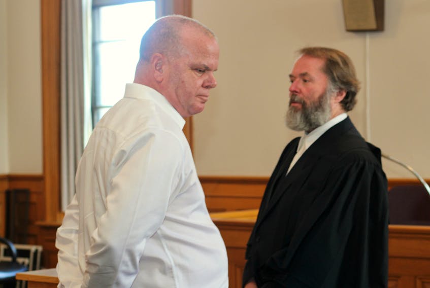 Mark Rumboldt (left), who is not in custody, stands in Newfoundland and Labrador Supreme Court alongside his lawyer, Jeff Brace, as his attempted murder trial wraps up for the day Monday.