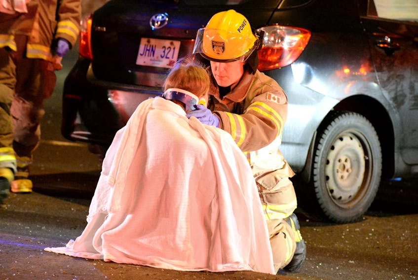 A St. John's firefighter assists one of three female accident victims after a serious accident Saturday night on Columbus Drive between Thorburn and Old Penneywell roads. Police say that alcohol is a factor in the crash. Now the sister of one of the victims has started a Go Fund Me page to help her. She says her sister, who is scheduled for surgery Monday, will require a very long recovery period.