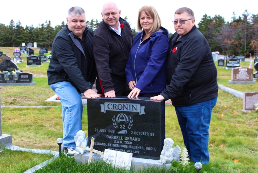 Keith Cronin, Blair Tilley, Michelle (Bursey) Walsh and Mike Walsh visit their brother, cousin and friend’s grave at St. Edwards Cemetery in Kelligrews. Darrell Cronin will be celebrated at Admiral’s Academy on Wednesday at 10:45 a.m., when the library in the school will be dedicated in his honour, marking 20 years since he lost his life in a helicopter crash on Quebec's Gaspé Peninsula while returning from a search-and-rescue mission.