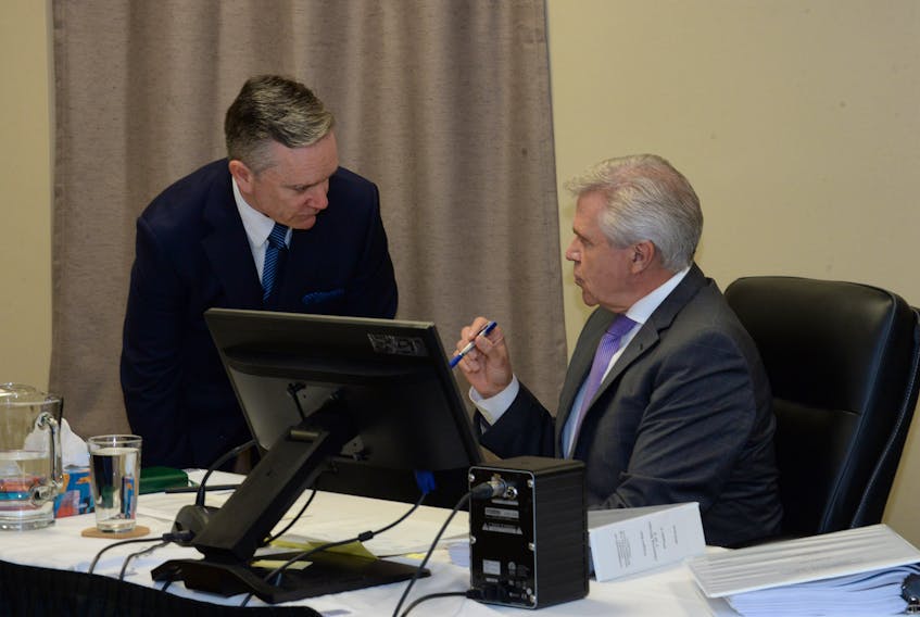 Premier Dwight Ball (right) speaks with his lawyer, Peter O’Flaherty, Friday morning at the Muskrat Falls Inquiry in St. John’s.