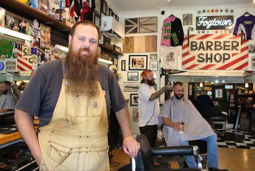 “Hef” (left), who works at Fogtown Barber Shop in downtown St. John’s, has groomed and shaved countless beards over the years, but said he wouldn’t think of shaving his. At right are Hef's colleague, Robbie Ryan, and patron Matthew Brown.
