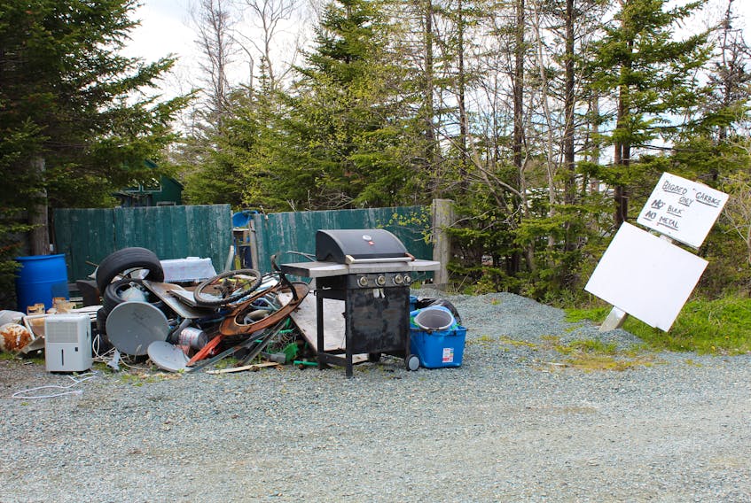 A pile of junk at the Cochrane Pond Family Campground. The sign specifies “Bagged garbage only.”