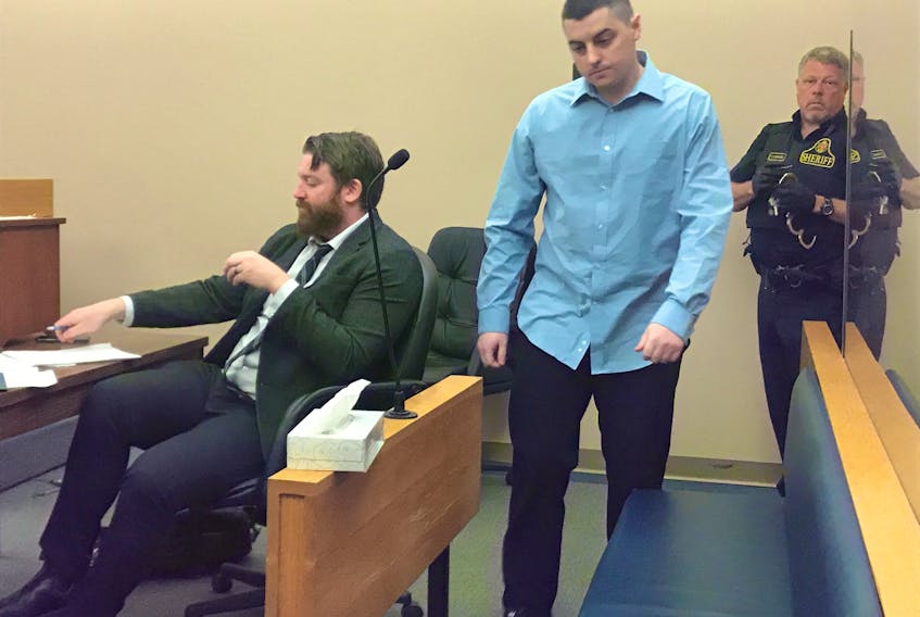 Michael Hannaford takes his seat behind his lawyer, Tim O’Brien, in provincial court in St. John’s Monday. Hannaford has pleaded not guilty to a number of charges, including the attempted murder of a woman he is alleged to have shot in May of last year.
