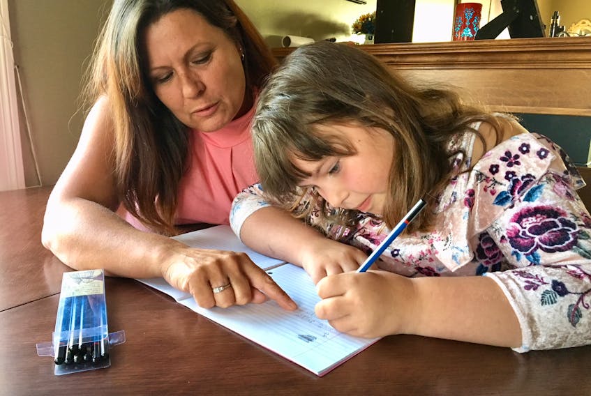 Shilo Stagg of Paradise teaches her eight-year-old daughter, Lexie, cursive writing regularly at home, since it’s not part of the school curriculum and, therefore, not a requirement in class.