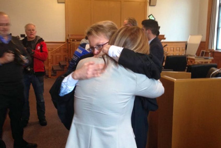 Crown prosecutor Dana Sullivan hugs a woman at Newfoundland Supreme Court in St. John’s Friday after Reginald Joseph O’Keefe was sentenced to five years in jail for molesting four children decades ago. O’Keefe sexually assaulted the woman’s three-year-old daughter in 2012 in a separate case.