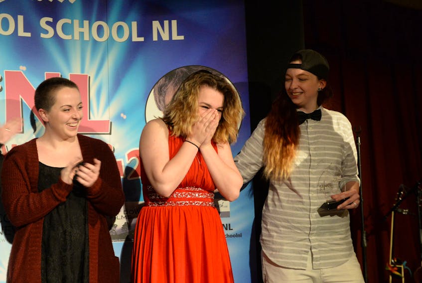Ally Noteworthy(centre) reacts as she wins the Sing NL adult category at the Bella Vista Sunday night. At left is fellow contestant Evelyn Ryan and at right is third place winner Emily Ball. — Keith Gosse/The Telegram