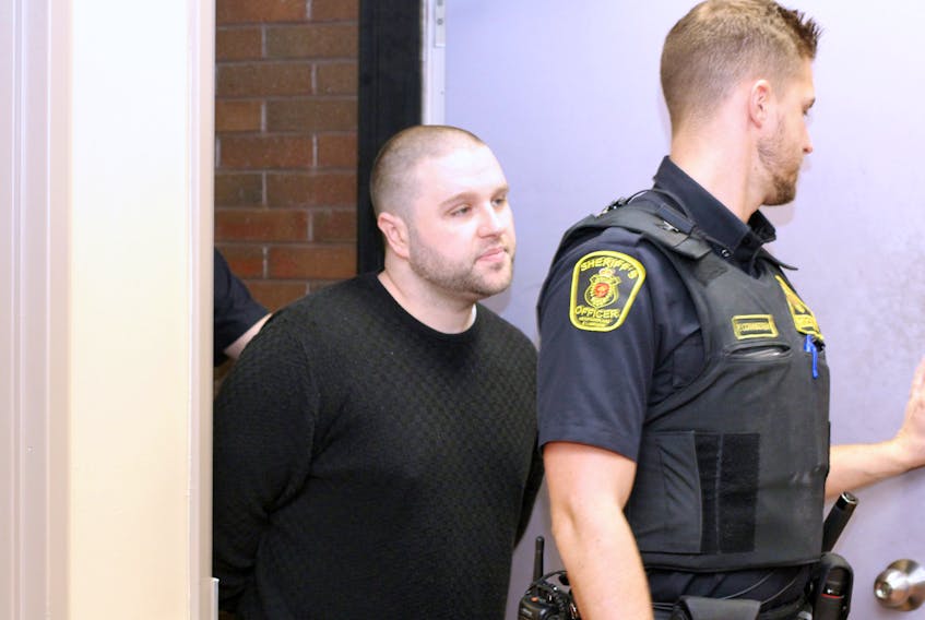 Dominic Delisle, 30, is escorted into provincial court in St. John’s Wednesday, where he was denied bail.