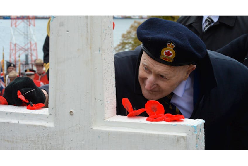 Second World War veteran Frederick Allister Downton, 95, places a poppy on the cross at the National War Memorial in downtown St. John’s after Monday’s Remembrance Day ceremony. Downton served as an engineer on ships with the Royal Canadian Navy during the war.