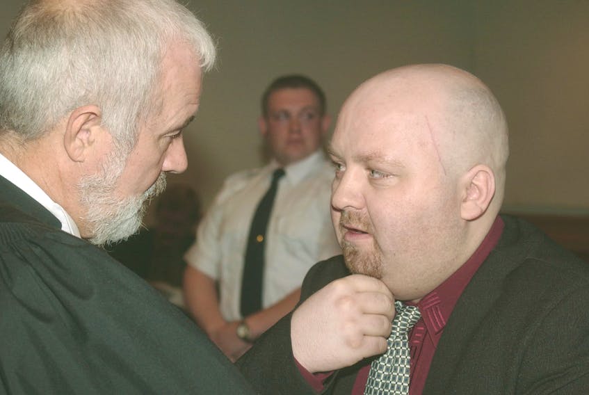 Brian Doyle (right) speaks to lawyer John Duggan in Newfoundland and Labrador Supreme Court in St. John’s in 2002. — Telegram file photo
