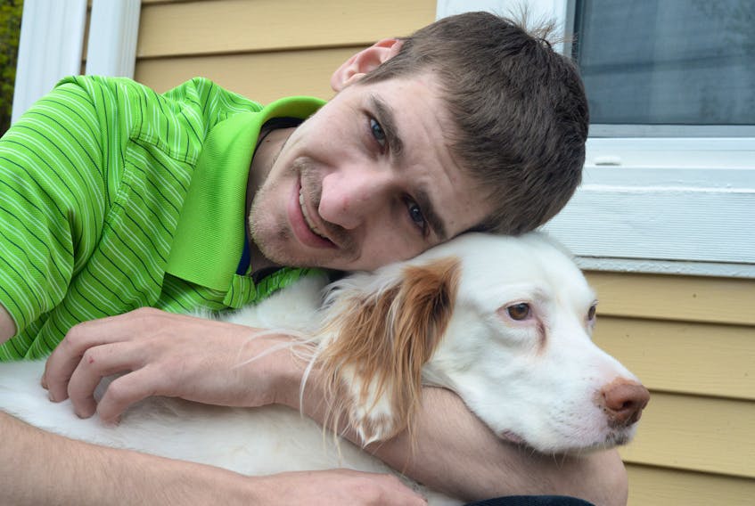 Colin Hannames, 28, of St. John’s, holds his dog, Babe, outside his west-end St. John’s home on Tuesday afternoon.