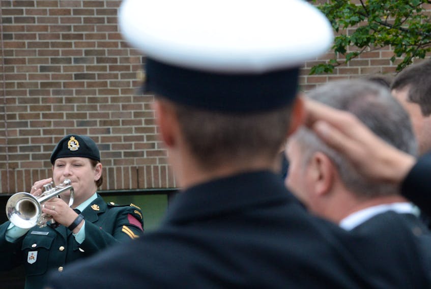 Cpl. Stephanie Furey of the Royal Newfoundland Regiment Band plays the Last Post and Reveille Thursday during the 21st annual Merchant Navy Memorial Service at the Merchant Navy Memorial on the grounds of the Marine Institute.