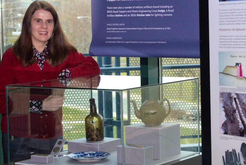 Anne Chafe, executive director of museums and galleries at The Rooms on Bonaventure Avenue in St. John’s, stands beside some of the artifacts on display from the Fort Townshend grounds and the site The Rooms is built on.