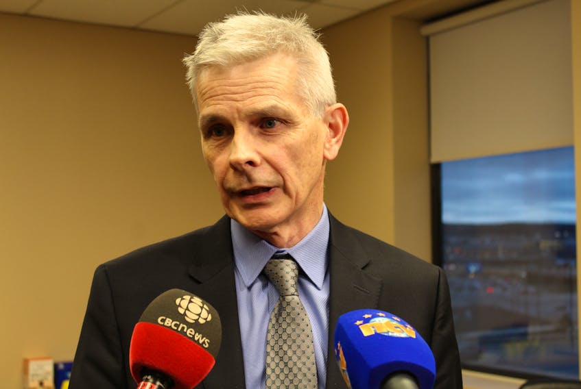 Robert Thompson, a former deputy minister of natural resources and former clerk of the executive council, speaks to reporters Thursday.