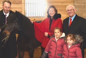 From left, Capital Campaign chairman Paul Antle, Patricia Fagan, Lt.-Gov. Frank Fagan and Antle’s daughters, Soleil, 5 and Cleo, 4, pose with Pickles, one of the horses at the new Rainbow Riders centre. Patricia Fagan is honorary patron of Rainbow Riders.