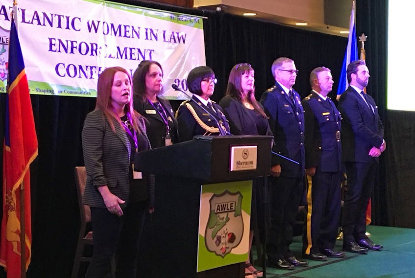 Local singer/songwriter Jackie Sullivan (left) sings the "Ode to Newfoundland" during the opening of the 27th Atlantic Women in Law Enforcement Conference (AWLE) at the Sheraton Hotel in St. John’s Wednesday. Guest speakers were (from left, after Sullivan), AWLE president Staff Sgt. Carolyn Nichols, RNC Insp. Sharon Warren, St. John’s Deputy Mayor Sheilagh O’Leary, RNC Deputy Chief Paul Woodruff, RCMP Assistant Commissioner Ches Parsons (commanding officer Newfoundland and Labrador) and Andrew Parsons, provincial minister of Justice and Public Safety.