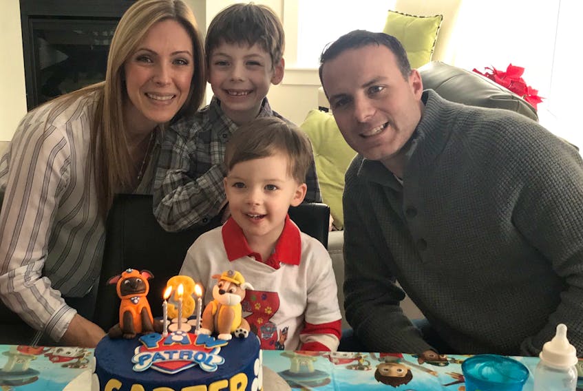 Jackson Brogan, now in Grade 1, is all smiles as he helps his little brother celebrate his third birthday in this family photo with his mother Lisa and dad Ryan. Jackson suffered a stroke at three weeks old and has battled through a number of side-effects since but is managing well and living as close to a normal childhood as possible.