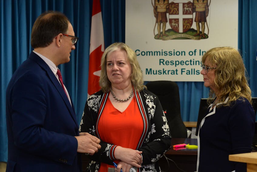 Retired Government of Newfoundland and Labrador finance department employee Donna Brewer (centre) chats with lawyers Peter Ralph and Gerlinde van Driel prior to Brewer taking the witness seat on Monday morning at the Commission of Inquiry Respecting the Muskrat Falls Project in the Beothuck Building on Crosbie Place in St. John’s.