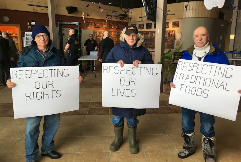 Members of the Labrador Land Protectors hold signs outside the public hearings for the Muskrat Falls Inquiry on Monday at the Lawrence O’Brien Arts Centre in Happy Valley-Goose Bay, as the hearings prepare to dive into the project’s construction costs. The group includes (from left) Eldred Davis, Jim Learning and John Learning.