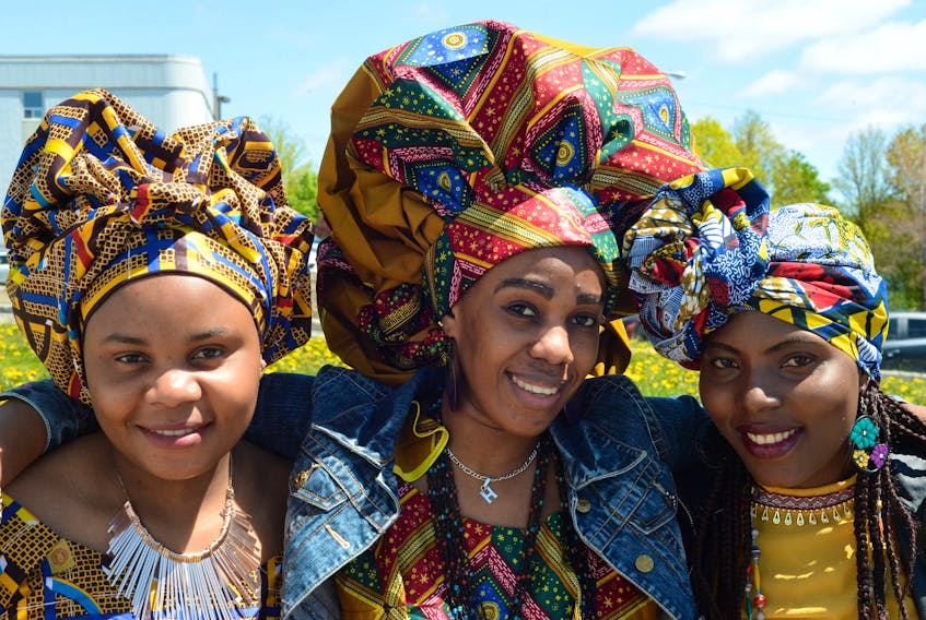 From left, English as a second language students Mauwa Ichard, Vanessa Aisha and Antoinette Kahindo wear traditional dress from their native Congo on Wednesday during Refugee Week activities at the Association for New Canadians (ANC) on Elizabeth Avenue.