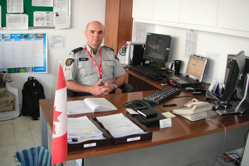 Bill Malone at work in his office as the deputy Canadian police commander in Kabul, Afghanistan. — Flanker Press