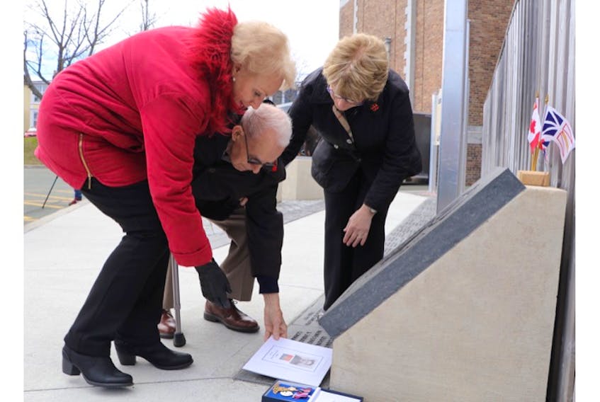 From left, Judith Holloway, Frank Pike and Pike’s daughter, Vicki Colbourne, unveil the engraved stone Monday for Frank’s oldest brother, Walter Kitchener Pike — a gunner with the Royal Artillery, 59 (Newfoundland) Heavy Regiment in the Second World War — who died in England in 1941.