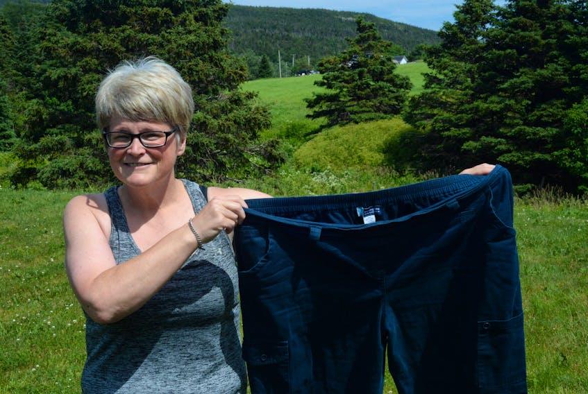 Kristina Squires holds a pair of pants that fitted her three years ago. Back then she weighed 266 pounds. Now, she’s back in shape, 107 pounds lighter and due to run her first Tely 10 Sunday morning.