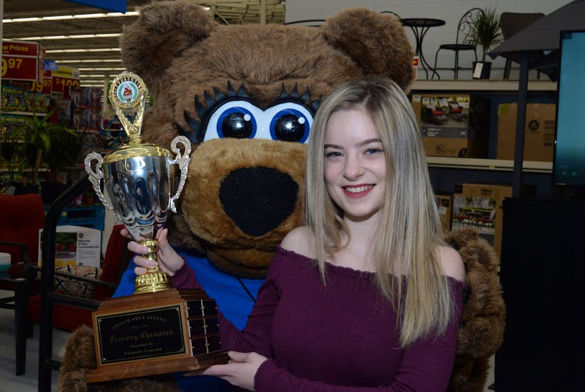 Hilary Warren, 15, with her Janeway Champion Child trophy, accompanied by Janeway mascot Sunny Bear.
