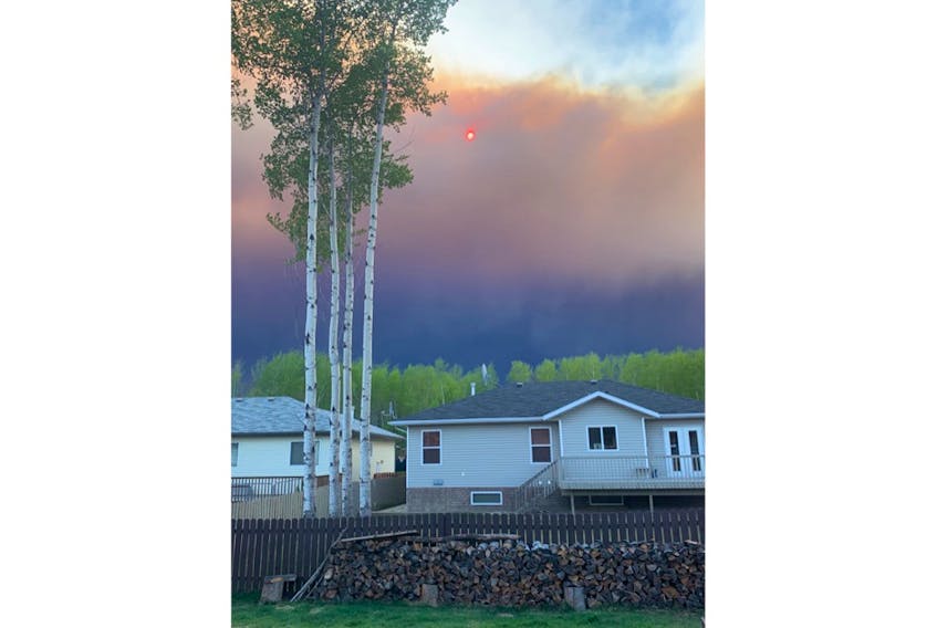 Before Newfoundland native Robyn Dwyer and her family evacuated from their High Level, Alta., home Monday, she snapped a few photos of the wildfire that was approaching the town.