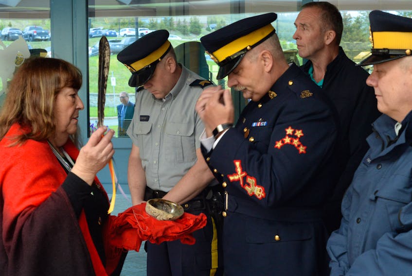 Odelle Pike of the Newfoundland and Labrador Aboriginal Women’s Network performs a smudging ceremony on RCMP Sgt. Maj. Doug Pack during Indigenous Peoples Day events at RCMP headquarters in Pleasantville on Friday.