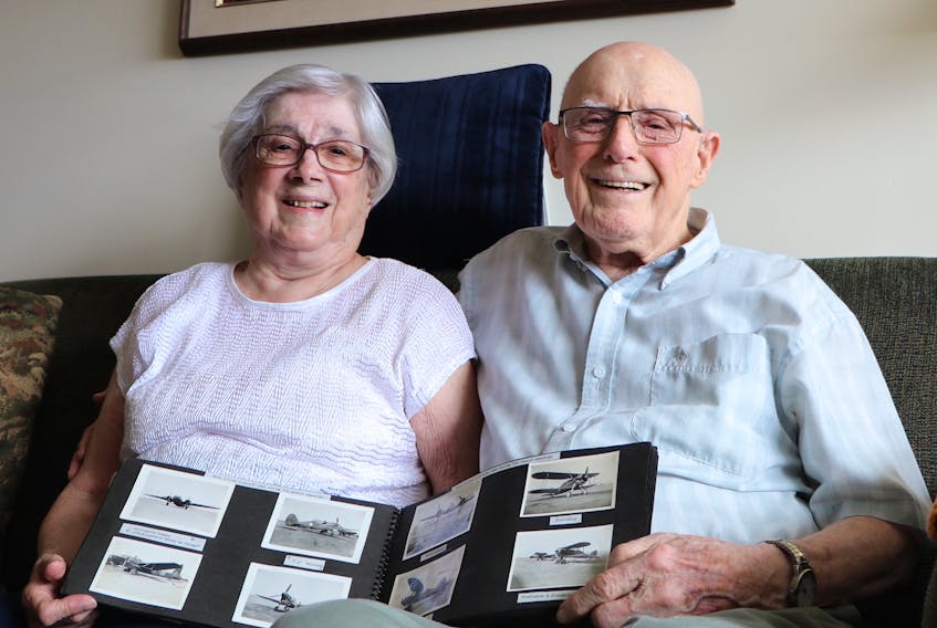Second World War veteran Elmo Baird, 99, and his wife, Eleanor, 96, hold a photo album that contains photos Baird took during his time with the Royal Air Force. The photos have rarely been seen by anyone outside of family and friends.