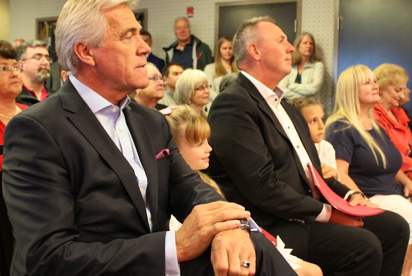 Premier Dwight Ball and Liberal candidate Paul Antle (right) await their chance to speak at Antle’s campaign launch on Wednesday morning in St. John’s.