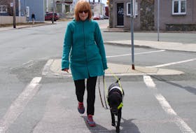 Anne Malone and her companion and guide dog, Cheryl, a Labrador retriever, take a walk along Merrymeeting Road in St. John’s Tuesday afternoon.