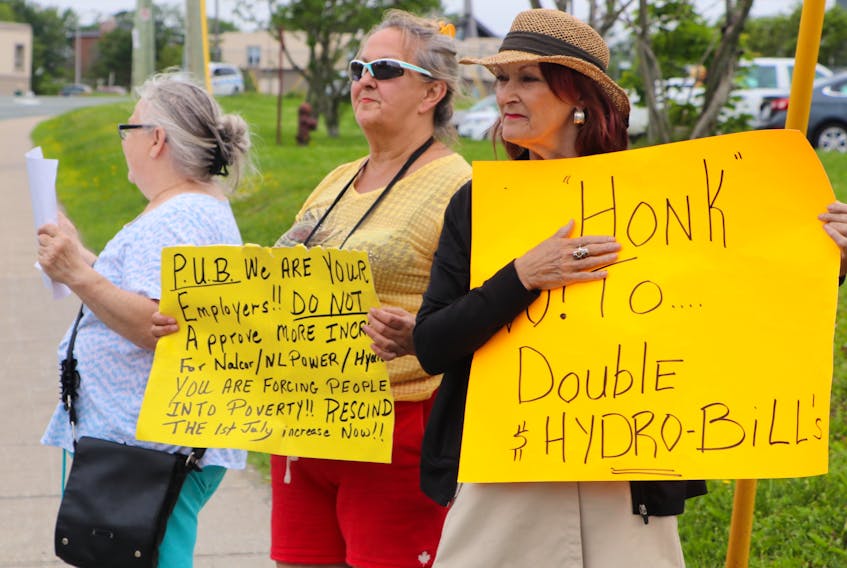 Protesters brought homemade signs that showed their disapproval of power rate increases.