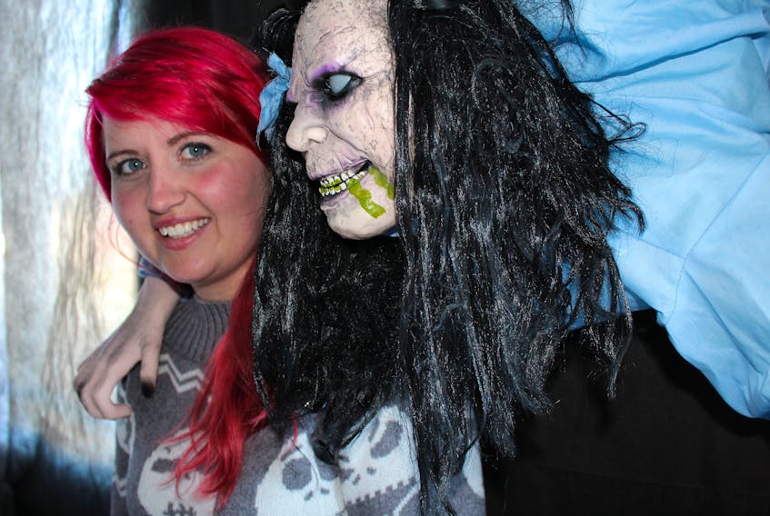Jessica Rockwood with one of many ghastly creatures inside her haunted house on Donovan Street in Mount Pearl.