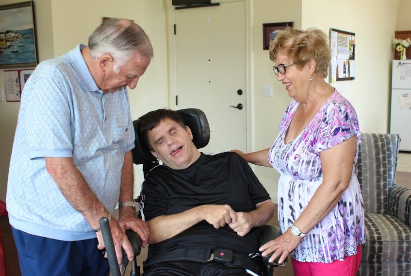 Tom Lush (left) and Lillie Lush (right) visit their son, Stephen Lush (centre) at his Tiffany Village residence.