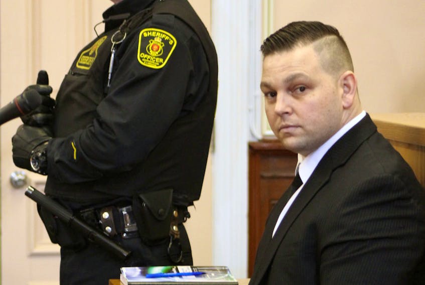 Craig Pope, 33, sits in the dock in Newfoundland and Labrador Supreme Court in St. John's Tuesday morning flanked by sheriffs, waiting for his second-degree murder trial to begin.