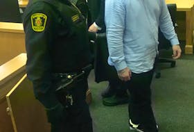 Graham Veitch, 21, looks toward his mother, Joan, in the gallery as he leaves the courtroom in St. John’s Thursday. It was the first time since his arrest in December 2016 that Veitch was permitted to have contact with his mom, since he had been ordered to have no communication with her. After declaring Veitch not criminally responsible for the killing of Joan’s partner, David Collins, Justice Sandra Chaytor agreed to lift the no-contact order.