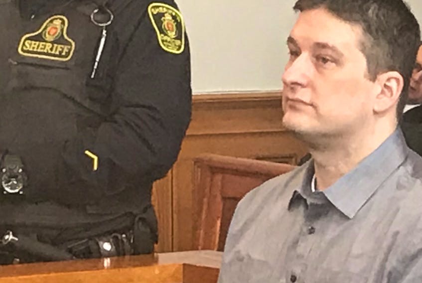 Trent Butt sits in the prisoner's dock in Newfoundland and Labrador Supreme Court in St. John's Monday, as jury selection for his murder trial began. The 14 jurors were chosen on Tuesday, and Butt's trial is set to begin Wednesday.