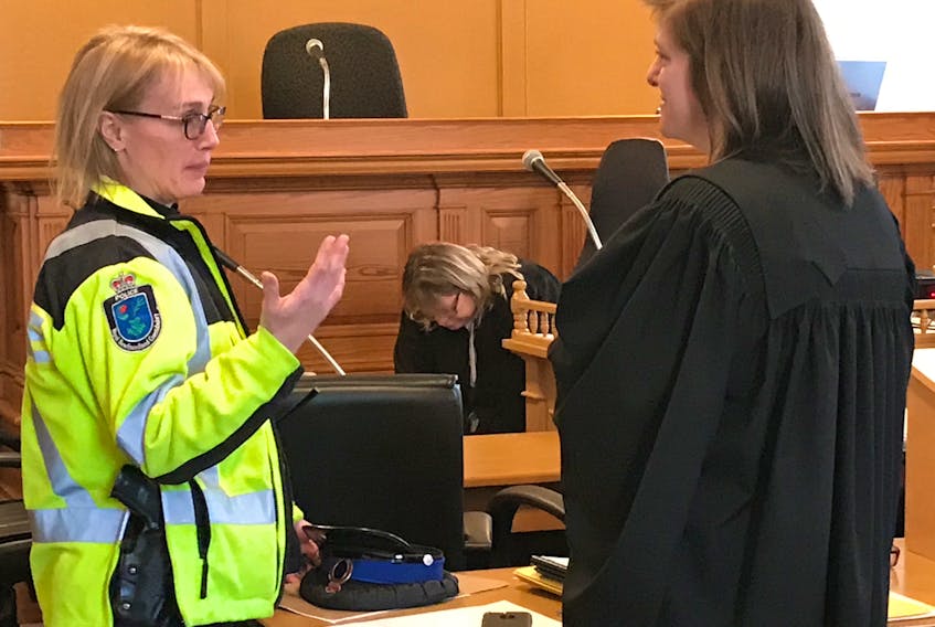 RNC Const. Karen Didham (left), a collision analyst, speaks with Crown prosecutor Jennifer Lundrigan during a break in the trial of Joshua Steele-Young in Newfoundland and Labrador Supreme Court in St. John's Thursday. Steele-Young, 23, is charged in connection with a car crash that left his ex-girlfriend paralyzed from the chest down.