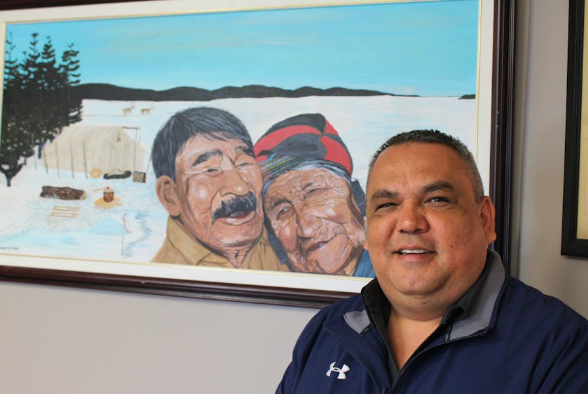 Chief Eugene Hart of the Sheshatshiu Innu First Nation stands beside a portrait of his grandparents, Mary Pasteen and Michel Pasteen, in his office in Sheshatshiu. The portrait was painted by Innu artist Mary Ann Penashue.