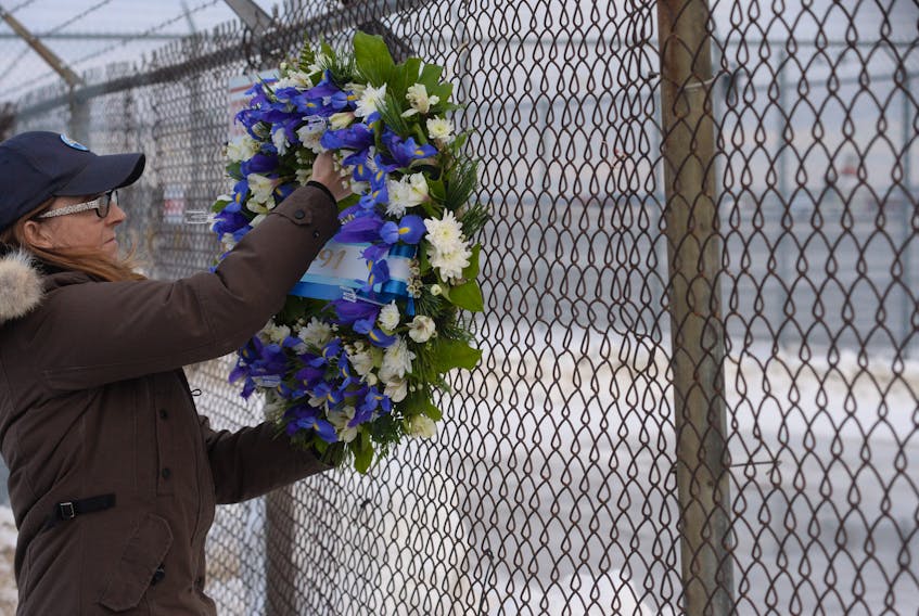 Lori Chynn of Deer Lake places flowers March 12, 2019 at St. John’s International Airport as a memorial to her husband, John Pelley, who lost his life in the crash of Cougar Helicopters Flight 491 on March 12, 2009. Chynn flew to St. John’s to take part in the anniversary events. - Joe Gibbons