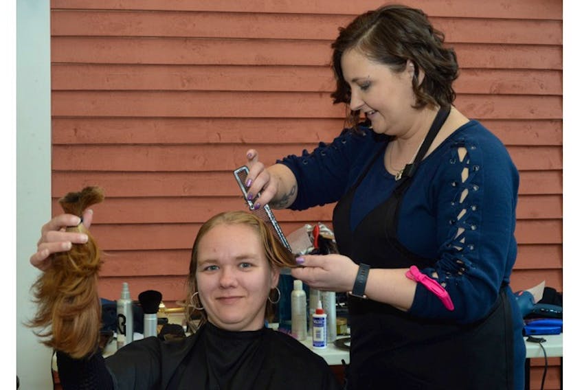 Inna Urouski, 33, gets a free haircut from stylist Holly French — of First Choice Haircuts on Kelsey Drive in St. John’s — at the Gathering Place on Military Road on Tuesday morning. Guests of the Gathering Place were offered free haircuts thanks to the First Choice Cares program.