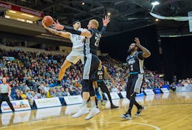 Jarryn Skeete of the St. John’s Edge scoops up a rebound as he’s guarded by Nick Evans of the Moncton Magic during play in Game 4 of the National Basketball League of Canada final Thursday night at Mile One Centre. Looking on is Moncton’s Corey Allmond (3).