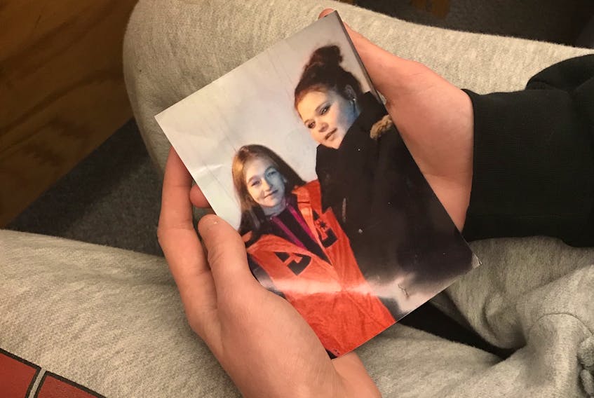 A member of Alyssa Power's family held a photo of Power (right) in the courtroom Monday, as Crown and defence lawyers argued a sentence for the teenage girl charged in connection with her death.