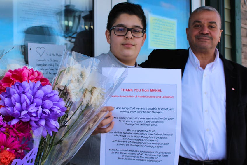 Moein Shahwan (right) and his son, Abdullah, are among the members of the Muslim Association of Newfoundland and Labrador who take comfort in the outpouring of support from the public after last week’s devastating attack in New Zealand. People have been leaving flowers and other mementos in front of the St. John’s mosque.
