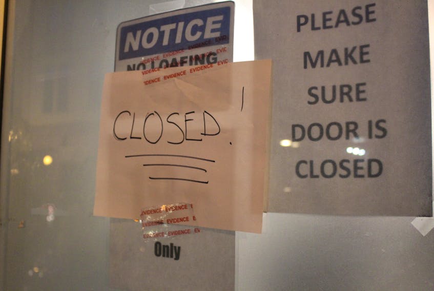 A “closed” sign on Cannabis Care’s door Thursday evening.
