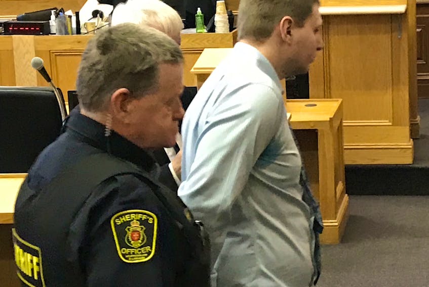 Brandon Coady, 24, is escorted by a sherrif's officer from Newfoundland and Labrador Supreme Court in St. John's to the lockup Monday morning. Coady will serve a six-year prison sentence for the attempted murder of Taylor King two years ago.