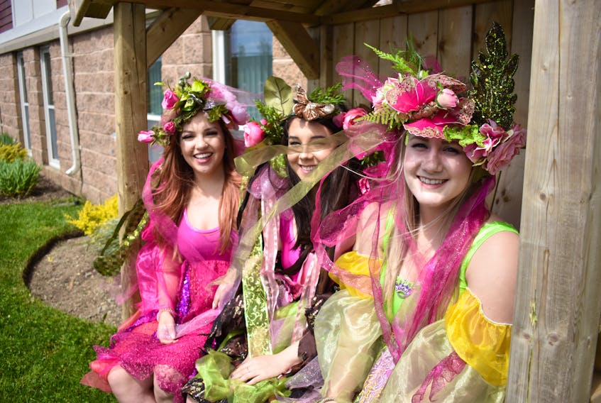 From left, Erin Pretty, Emily Winters, and Jennifer Mackey dressed as their garden fairy characters Pink, Blossom, and Hope for the tree planting ceremony. Mackey had to work at the ER, but she asked for two hours off to be a garden fairy on Thursday.